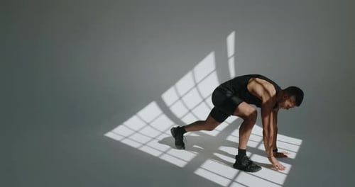 Athletic Man Doing Twisting Lunge Workout Indoors