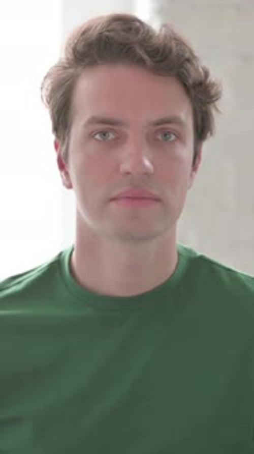 Serious Young Man Looking at the Camera, Vertical Video