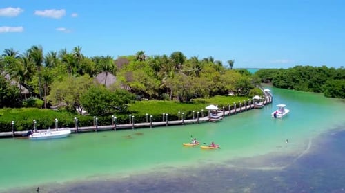 Couple kayaking adventure off a tropical island paradise in the bahamas