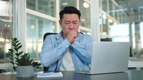 Man With Sore Throat at Office Desk