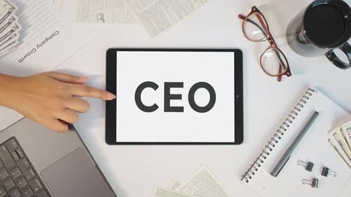 Tablet Displays CEO on Clean Desk, Top View