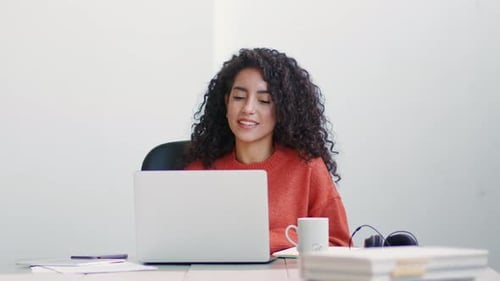 Happy Latin Business Woman Having Video Call Hybrid Meeting in Office