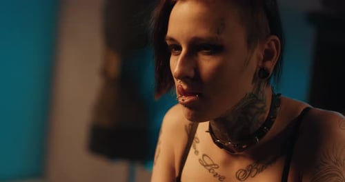 Tattooed Woman with Piercings and Spiked Choker