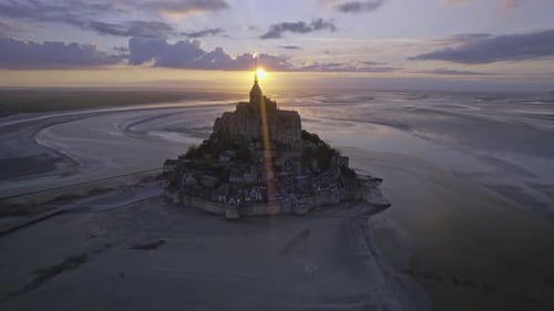 Aerial view of Mont Saint Michel at low tide during sunset, France.