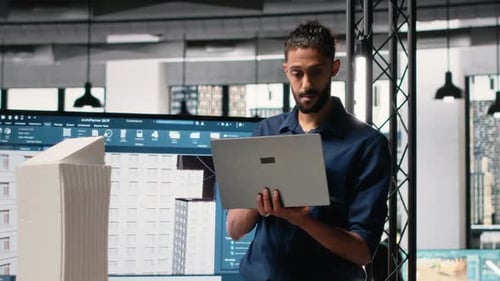Male Real Estate Engineer Studying Smart City Design and Buildings Layout