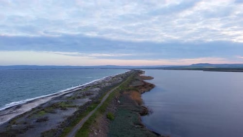 Bird's Eye View of Beach with Sand Grass and Stones Washed By Bay of Black Sea and Lake Under Sky in
