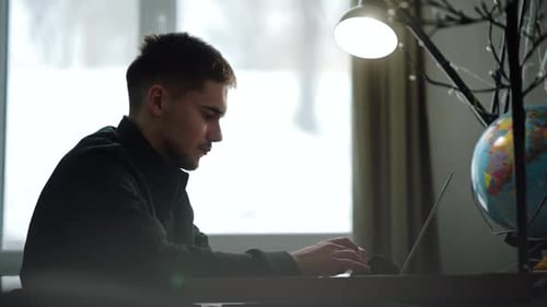 Man Working on Laptop in Home Office