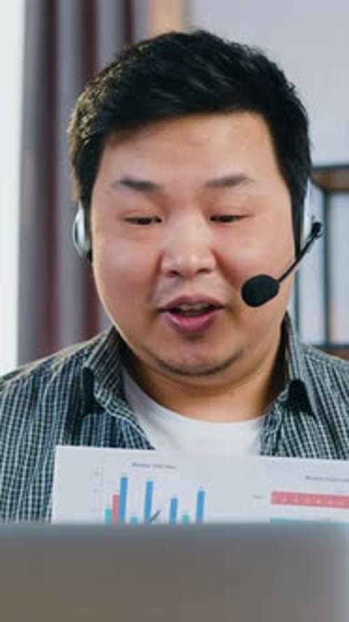 Man with Headset Presents Sales Data Charts