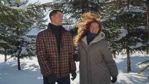 Dancing Family Couple in the Middle of a Winter Park The Young Man Dances with His Wife and Then