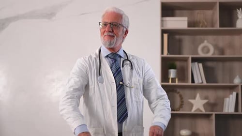 Mature Senior Male Doctor in Glasses Medical Uniform Smiling Looking at Camera in Hospital or Doctor