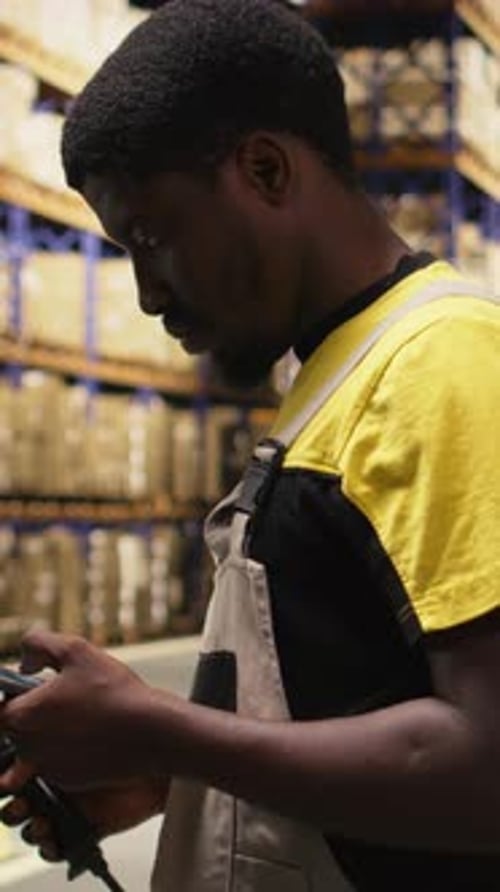 Vertical Video African American Man Using Scanner to Register Barcodes Tags in Inventory