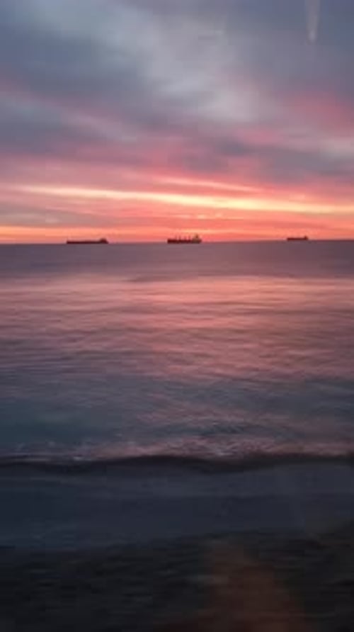 Silhouettes of the Cargo Ships at Sunset at Sea Cargo Transportation Shipping Logistics Services