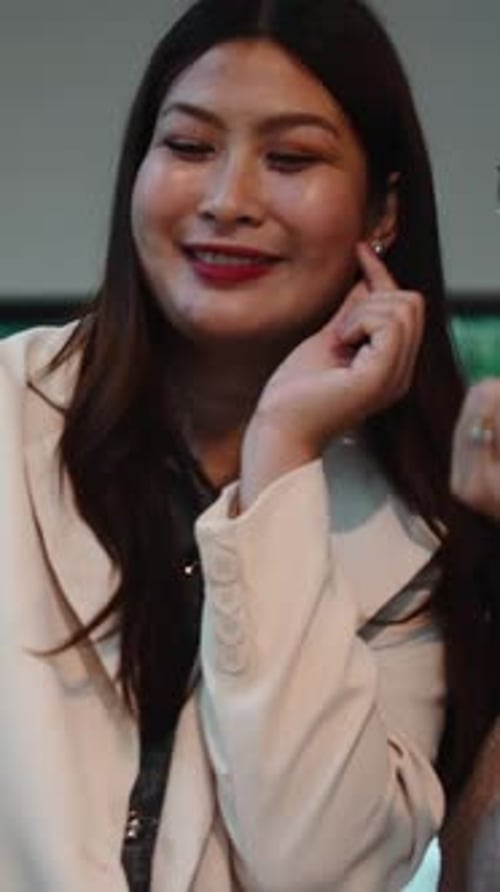 Smiling Woman with Long Dark Hair Posing Indoors