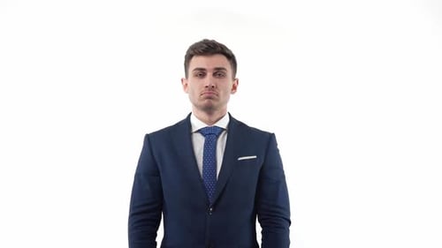 Thoughtful Young Man in Suit Posing in Studio