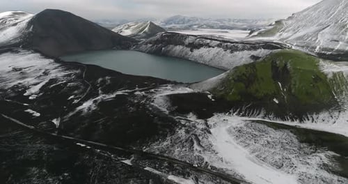 aerial view on iceland landscape with green mountains with snow and Lifrarfjallavatn lake