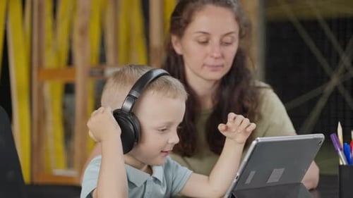 Boy Learning with Tablet and Headphones at Home