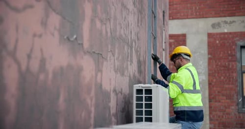 Technician, building and man climbing ladder for maintenance, aircon installation or inspection