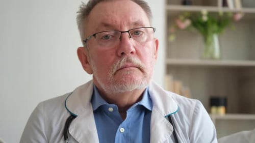 Mature Senior Male Doctor in Glasses Medical Uniform Smiling Looking at Camera in Hospital General