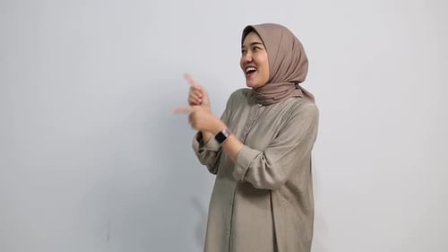 Smiling Woman Pointing and Presenting on White Background