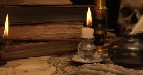 Ancient Books and Skull with Candlelight