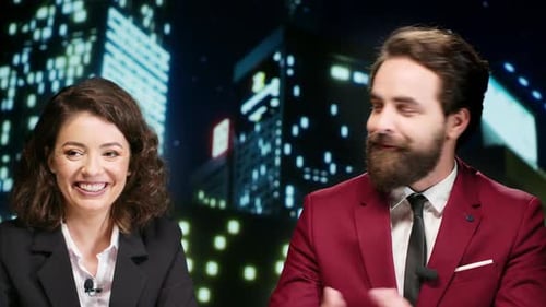 News Anchors in Television Studio at Night