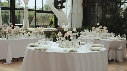 Wedding Reception Tables with Flowers and Place Settings