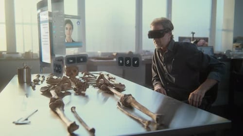 Man Using Augmented Reality to Study Skeleton
