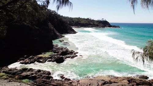 Idyllic Beach With Foamy Ocean Waves And Tropical Vegetation In Noosa, Queensland, Australia - Drone