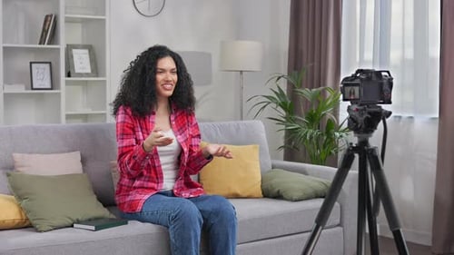 Woman Addresses Camera from Couch in Living Room