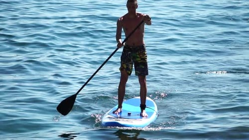 Man Sup Sea Strong Athletic Man Learns to Paddle Sup Standing on Board in Open Sea Ocean on Sunny