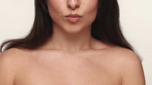 Beautiful Woman Smiling and Biting Lip in Close Up