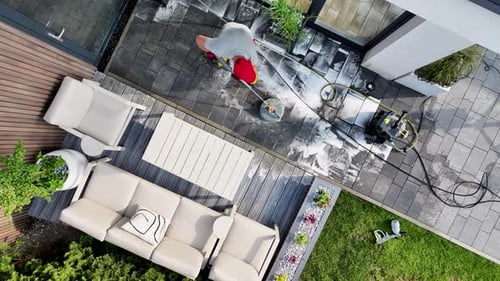 Outdoor Cleaning of Patio Area With Pressure Washer on Sunny Day