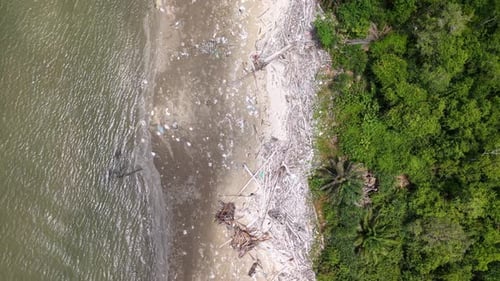 Aerial view of floating rubbish scattered across the beach