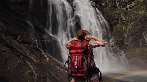 Travel Woman Enjoy Amazing View of Waterfall Nature
