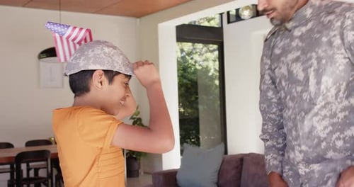 Boy and Military Man Salute Each Other at Home
