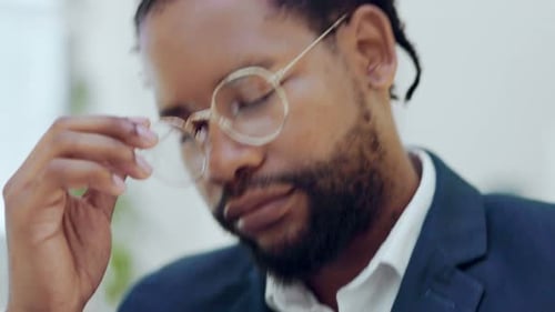 Stressed Man Working on Laptop in Office