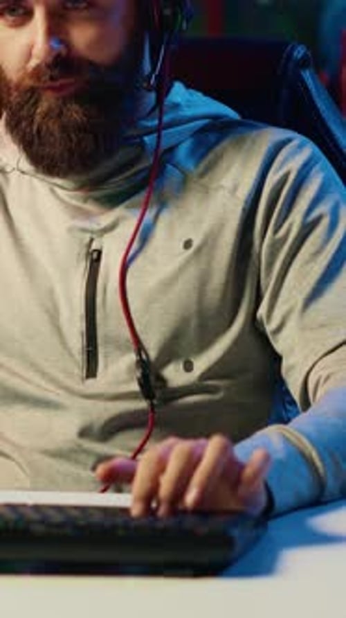 Vertical Video Close Up Shot of Pro Gamer Broadcasting Game on Internet Talking with Audience