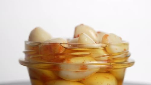 A jar of pickled garlic cloves.