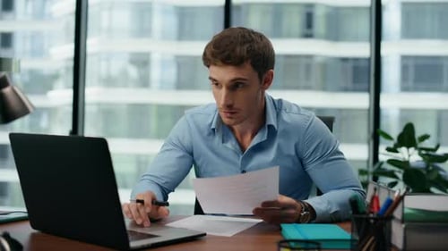 Young Adult Celebrating Success at Modern Office Desk