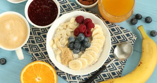 Overhead Shot of Oatmeal Breakfast Toppings with Coffee