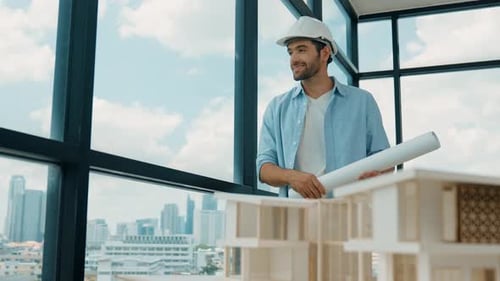 Professional engineer walking while looking at skyscraper view. Tracery