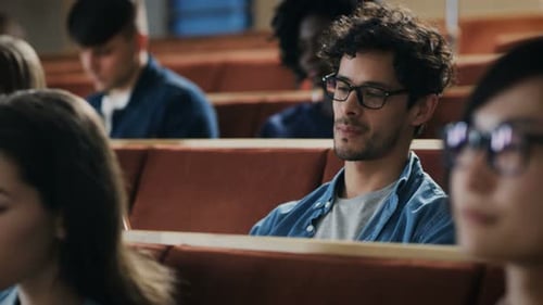 Attentive students listening to lecture in university hall