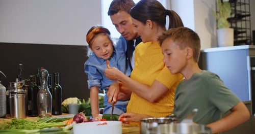 Happy Family Prepares Food Together in Kitchen