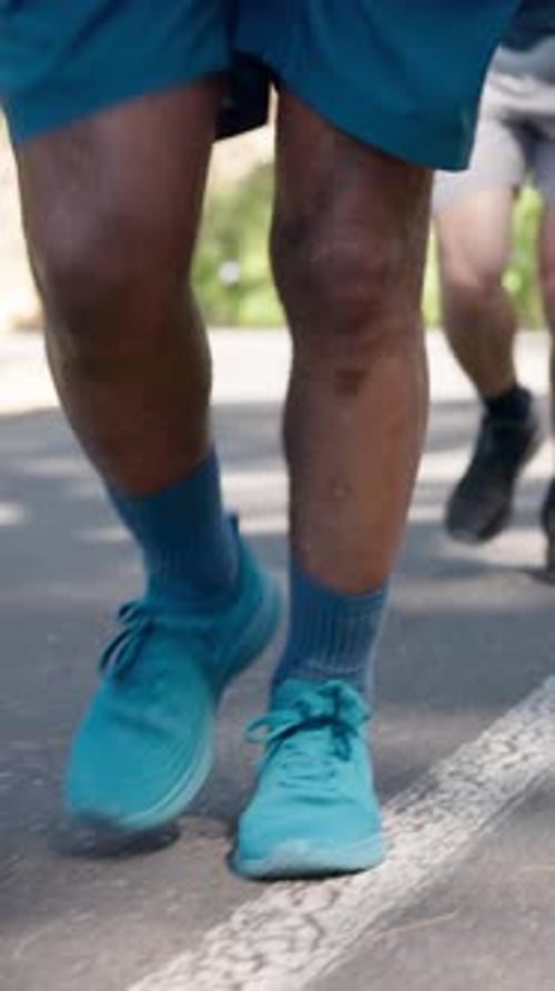 Legs, running and men in street, fitness for health benefits and intense training for challenge