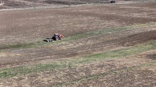 Tractor Tilling Field in Rural Setting