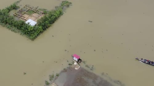 Aerial view boat assistance arrival in flood affected Bangladesh village submerged community crisis