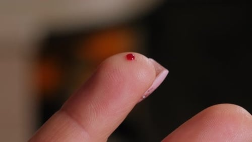 Close Up of Blood Droplet on Finger