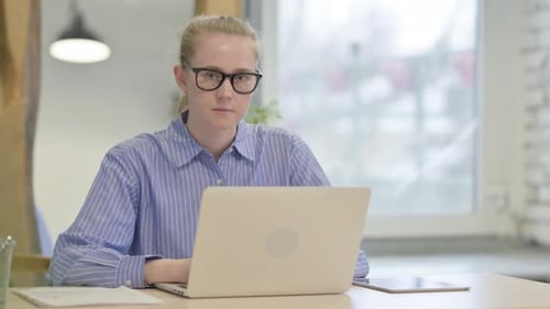 Surprised Woman Working at Computer in Office