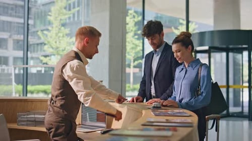 Hotel Receptionist Welcome Guests at Modern Counter Smiling Man Woman Check in