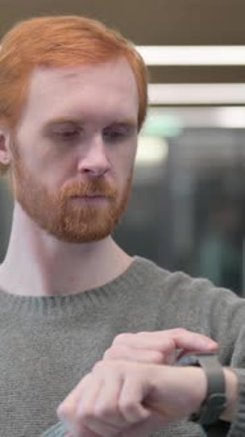 Portrait of Young Man using Smart Watch, Vertical Video